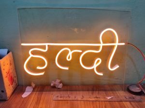 Custom LED neon printing services creating unique and eye-catching haldi ceremony decorations.